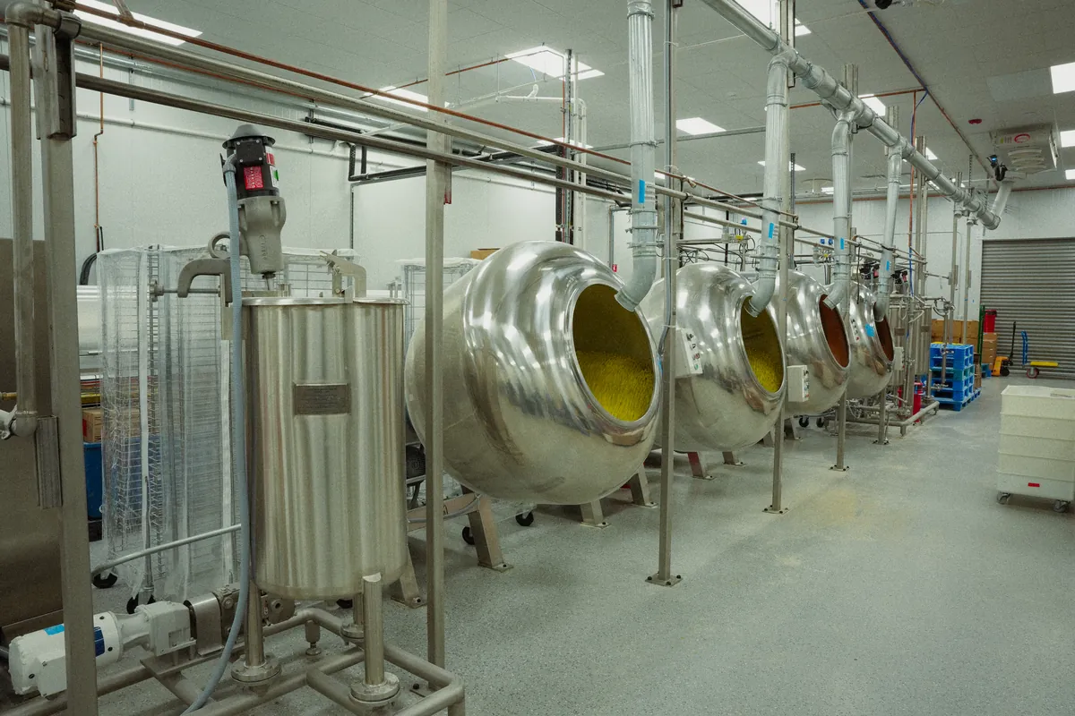 Rows of stainless-steel drums connected to overhead pipes in the Lion Labs production room.